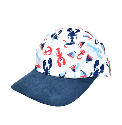 UPF 50+ Cam-Cam Cap - Sunday Sails. White baseball cap with red and blue lobsters, sailboats, and anchors. Navy blue brim.