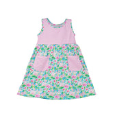 Flap Happy Kids UPF 50+ sleeveless dress with pockets Lotus and Lillies for sun protection. The Print is white background with  green Lotus and Pink Lillies.