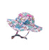 Flap Happy Kids UPF 50+ Floppy Sun Hat in Island Doddles . The print has colorful icons of palm trees, with water waves, rainbows and sail boats on a pink background.