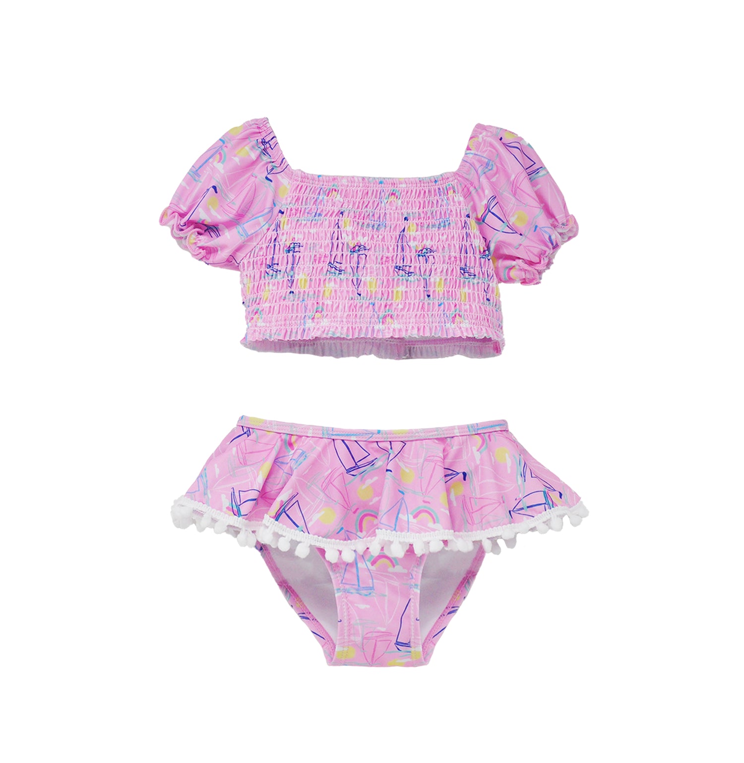 Flap Happy Kids UPF 50+ Sail Away Two Piece Smocked Pom-Pom swimsuit for sun protection. The Print is Pink with white, blue sail boats. also includes  bright yellow suns and rainbows.