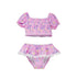 Flap Happy Kids UPF 50+ Sail Away Two Piece Smocked Pom-Pom swimsuit for sun protection. The Print is Pink with white, blue sail boats. also includes  bright yellow suns and rainbows.