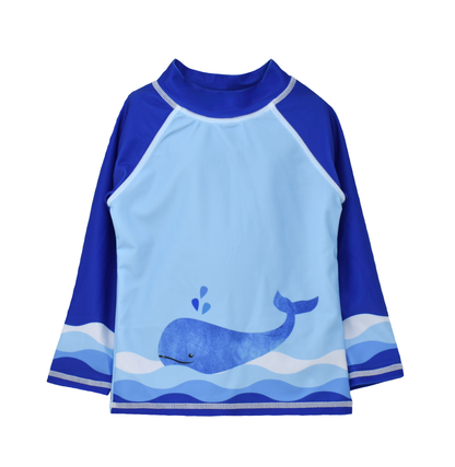 UPF 50+ Graphic Rash Guard Swim Top - Splish Splash Whale Blue. Light blue rashguard with watercolor blue whale and waves on front. Navy sleeves and neck. Waves graphic on ends of sleeves.
