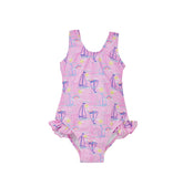 Flap Happy Kids UPF 50+ Infant hip Ruffle swimsuit in Sail Away for sun protection. The Print is pink with blue, pink and white sail boats. surrounded with bright yellow suns and rainbows. 