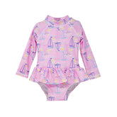  Flap Happy Infants UPF 50+ Ruffle Rash Guard swimsuit in Sail Away. The print has Blue and Pink colored  sail boats. With bright yellow sun and  small colorful rainbows.  
