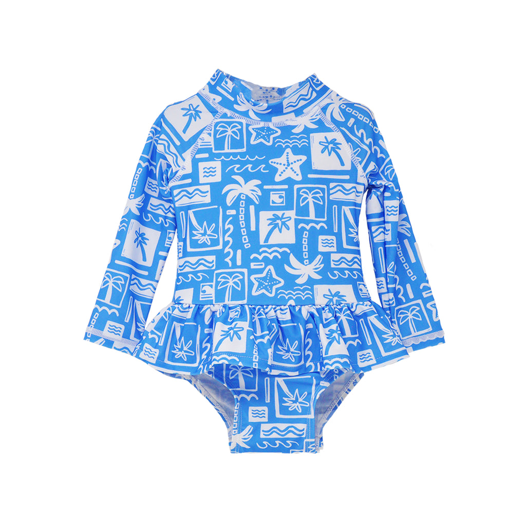  Flap Happy Infants UPF 50+ Ruffle Rash Guard swimsuit in Seaside Palms. The print has white icons of palm trees, water waves and starfish on a blue background.