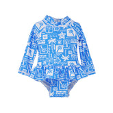  Flap Happy Infants UPF 50+ Ruffle Rash Guard swimsuit in Seaside Palms. The print has white icons of palm trees, water waves and starfish on a blue background.