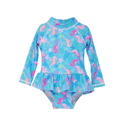  Flap Happy Infants UPF 50+ Ruffle Rash Guard swimsuit in Seahorse Garden. The print has Pink and Orange seahorses, under water gardens on a blue background.