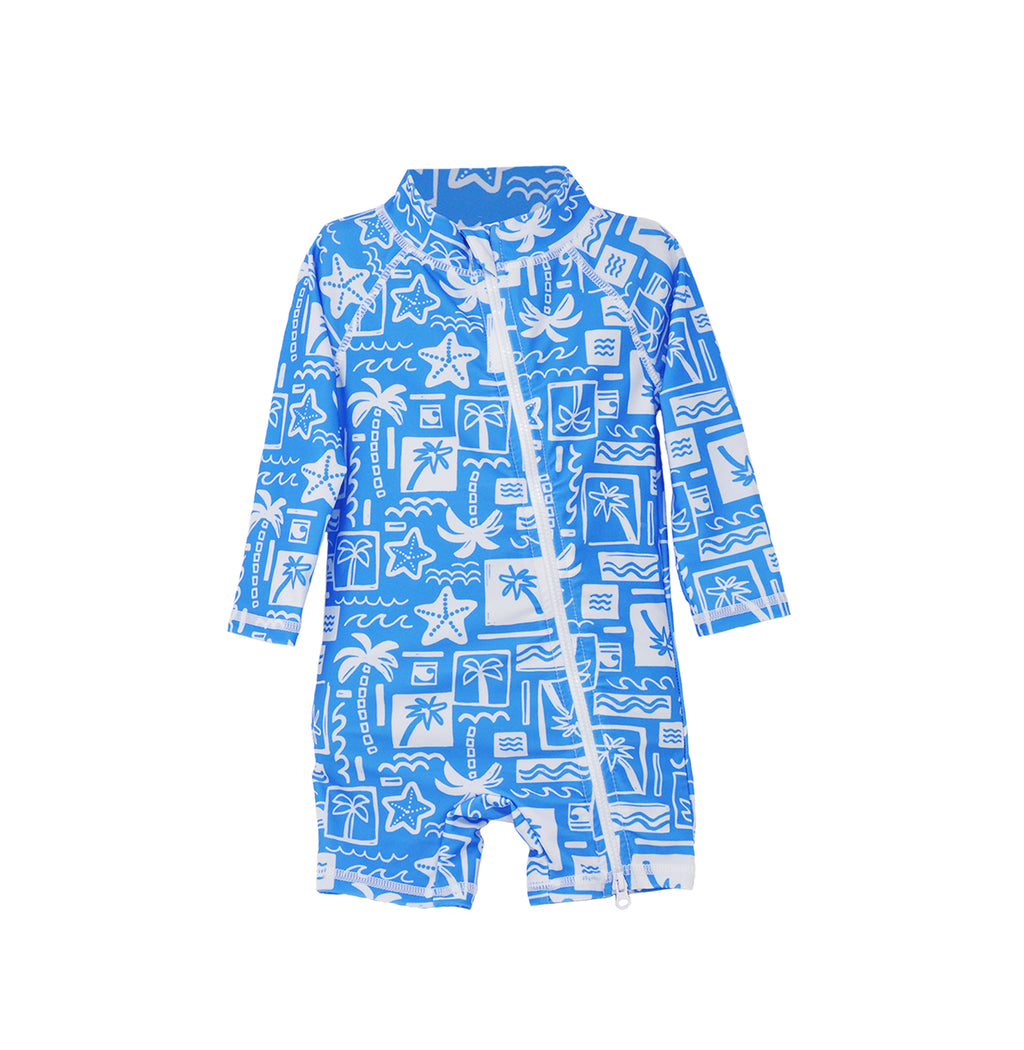 Flap Happy Kids UPF 50+ Shorties Surf Swimsuit in Seaside Palms for sun protection. The print has white icons of palm trees, water waves and starfish on a blue background.