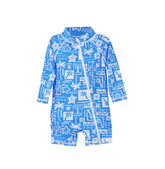 Flap Happy Kids UPF 50+ Shorties Surf Swimsuit in Seaside Palms for sun protection. The print has white icons of palm trees, water waves and starfish on a blue background.