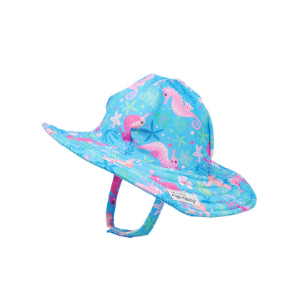 Flap Happy Kids UPF 50+ Summer Splash Swim Hat in Seahorse Garden  for sun protection. The Print has Orange and pink Seahorses. Surrounded by under the sea leaves and flowers.