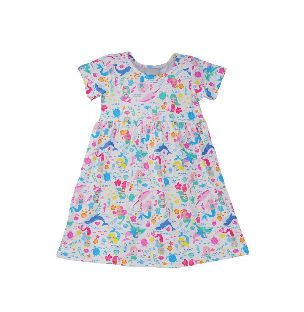 Flap Happy Kids UPF 50+ Short sleeve tee dress Mermaid Friends for sun protection. The print has white background colorful mermaids, whales, fishes and turtles.