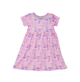 Flap Happy Kids UPF 50+ Short sleeve tee dress Sail Away for sun protection. The print has Blue, Pink and white sail boats. surrounded by bright yellow suns and color rainbows.