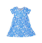 Flap Happy Kids UPF 50+ Short sleeve tee dress Seaside Palms for sun protection. The print has white icons of palm trees, water waves and starfish on a blue background.