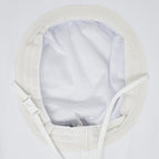 Close-up of the inside of a white sun hat  showing a white mesh lining, adjustable strap, and stitched edge on a white background.